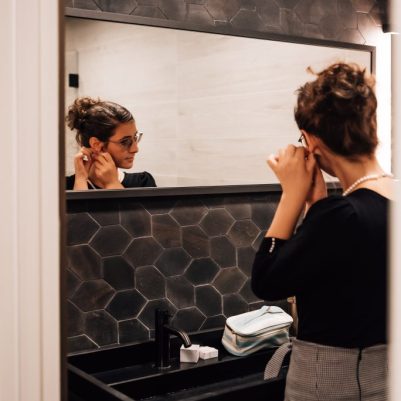 Woman putting on earrings