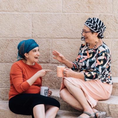 Two women laughing outside