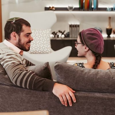 Couple sitting on couch smiling 2