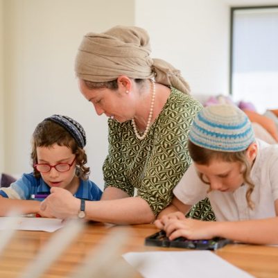 Mother helping sons color