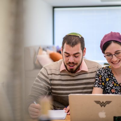Couple laughing at computer screen 3