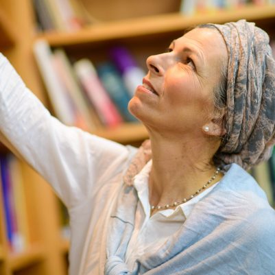 Woman looking for a book in library