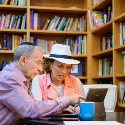 Couple discussing work in library