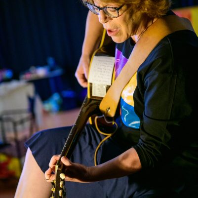 Woman performing guitar in concert 3