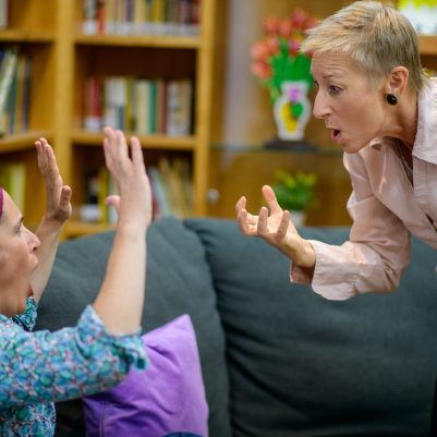Two women animated in discussion 1