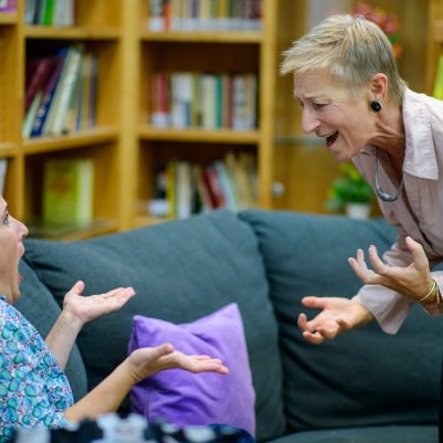 Two women animated in discussion 2