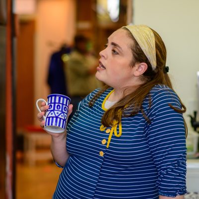 Woman holding coffee mug in kitchen