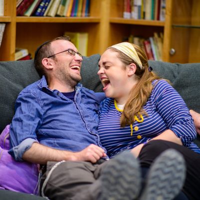 Couple laughing on couch