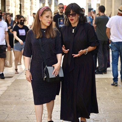 Two women walking in mall 2