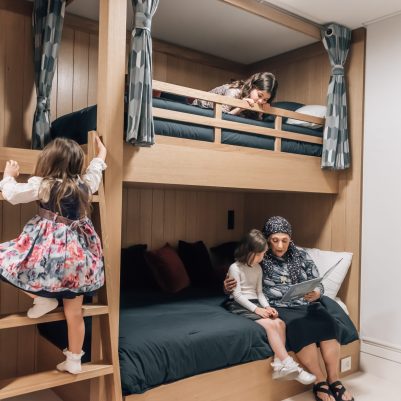 Grandmother reading book to granddaughters