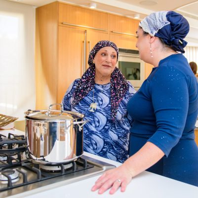 Two women talking in kitchen