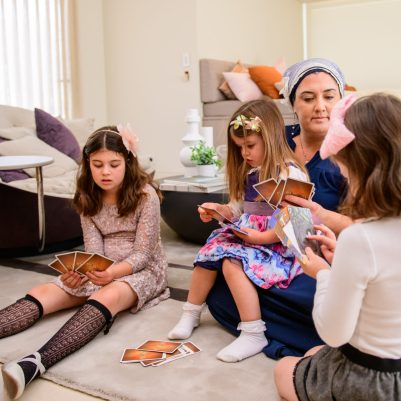 Mother playing cards with daughters 1