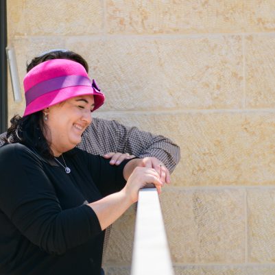 Romantic picture of husband leaning on wife, wife smiling outside  3