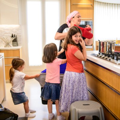 Daughters interrupting mother cooking 2