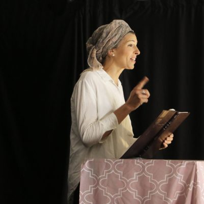 Woman teaching Torah to audience