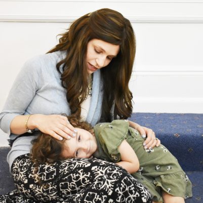 Mom comforting young daughter