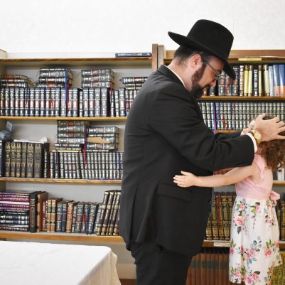 Father blessing young daughter