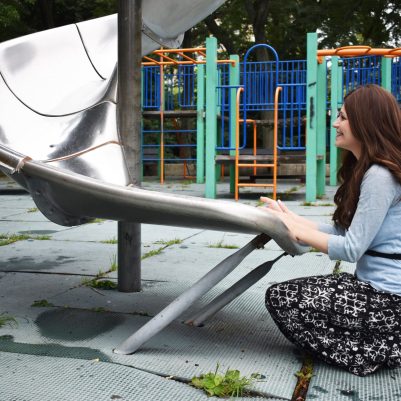 Mother waiting for child at slide