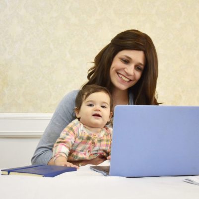 Mother working at home with toddler 1
