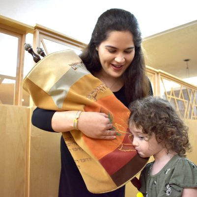 Little girl kissing Torah 3