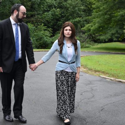 Couple holding hands on a walk 1