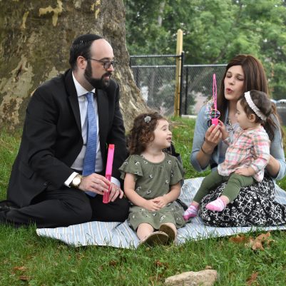 Family sitting on the grass 1