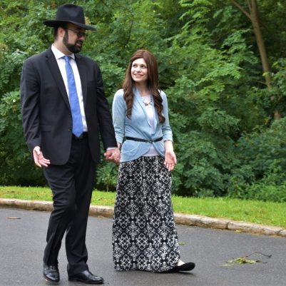 Husband and wife holding hands outside