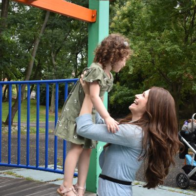 Mother and daughter playing in park