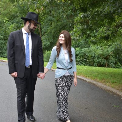 Couple holding hands looking at each other