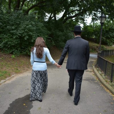 Couple walking in park holding hands