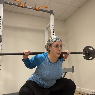 Woman in scarf lifting weights