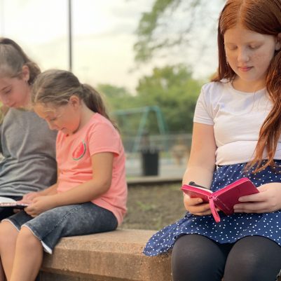 Young girls praying outside