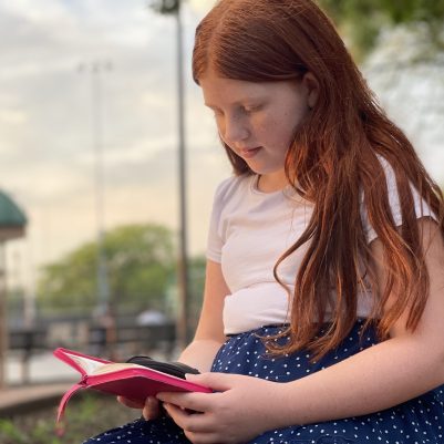 Young girl praying outside 2