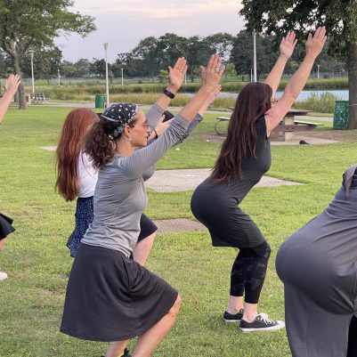 Mothers and daughters exercising in park 3