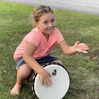 Young girl playing a drum 2