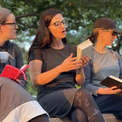 Women learning in park with siddurs 1