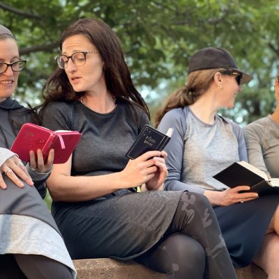 Women learning in park with siddurs 3