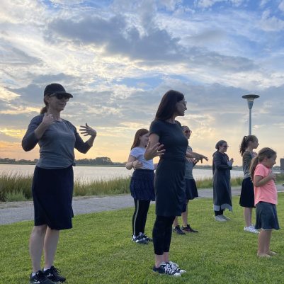 Mothers and daughters exercising in park 5