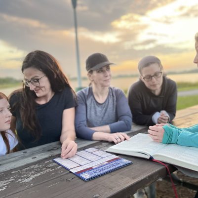 Women learning in park with daughters