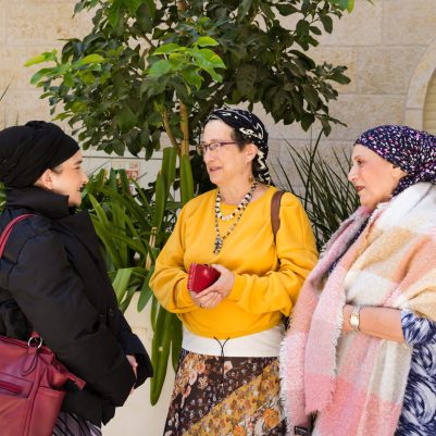 Women in coats talking