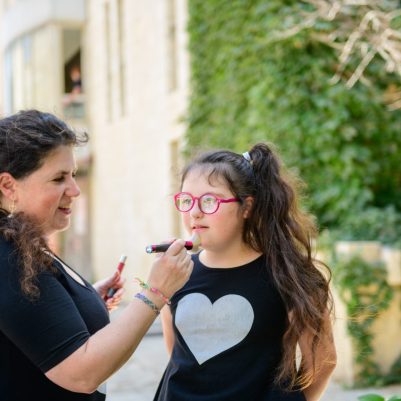 Makeup artist with little girl