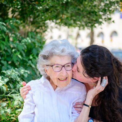 Daughter kissing mom on cheek