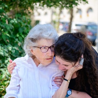 Mom kissing daughter on cheek