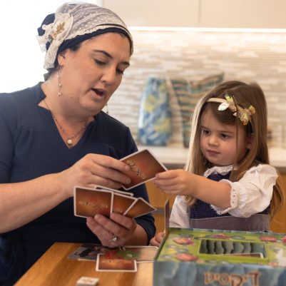 Mother and daughter playing board game 1