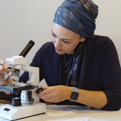 Scientist using microscope