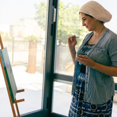 Artist looking at canvas