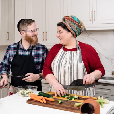 Couple chopping vegetables