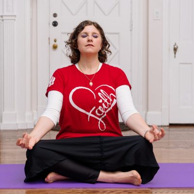Woman sitting on yoga mat 1