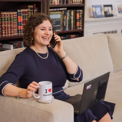 Woman talking on phone and working on laptop 2