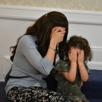 Mother and daughter covering eyes